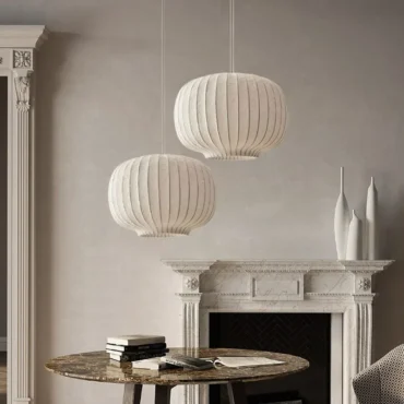 Henningsvær silk pendant lights hanging above a mantelpiece