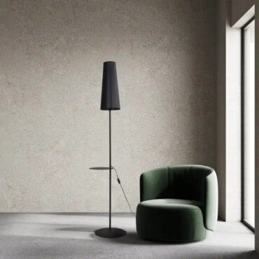 Bodø black slim floor lamp beside an armchair