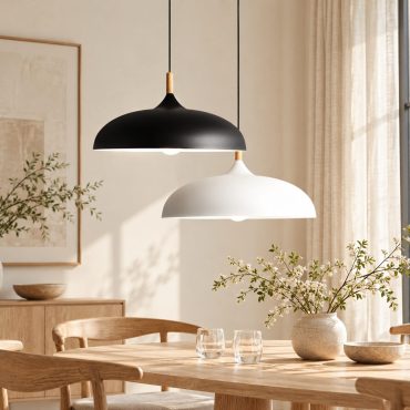 Kumla aluminium and wood pendant lights in white above a dining table.